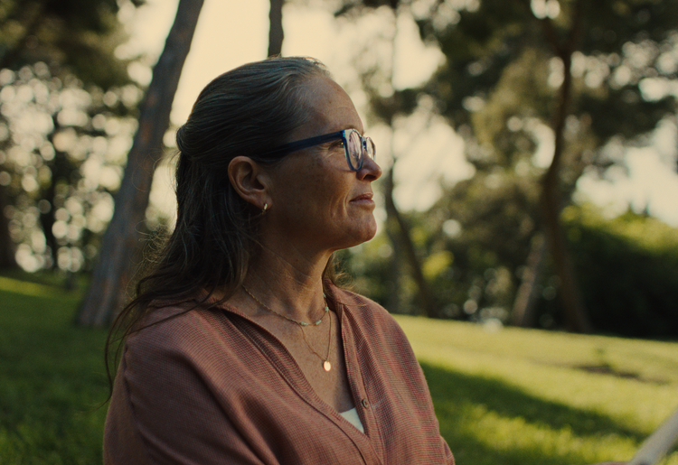 Stylish woman with glasses and earrings in a relaxed park environment