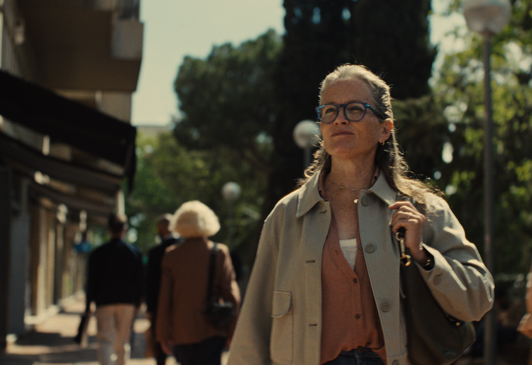Female patient walking past quaint storefronts en route to her doctor’s office